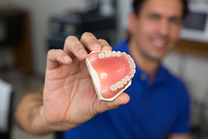 man holding dentures | Mansfield, OH